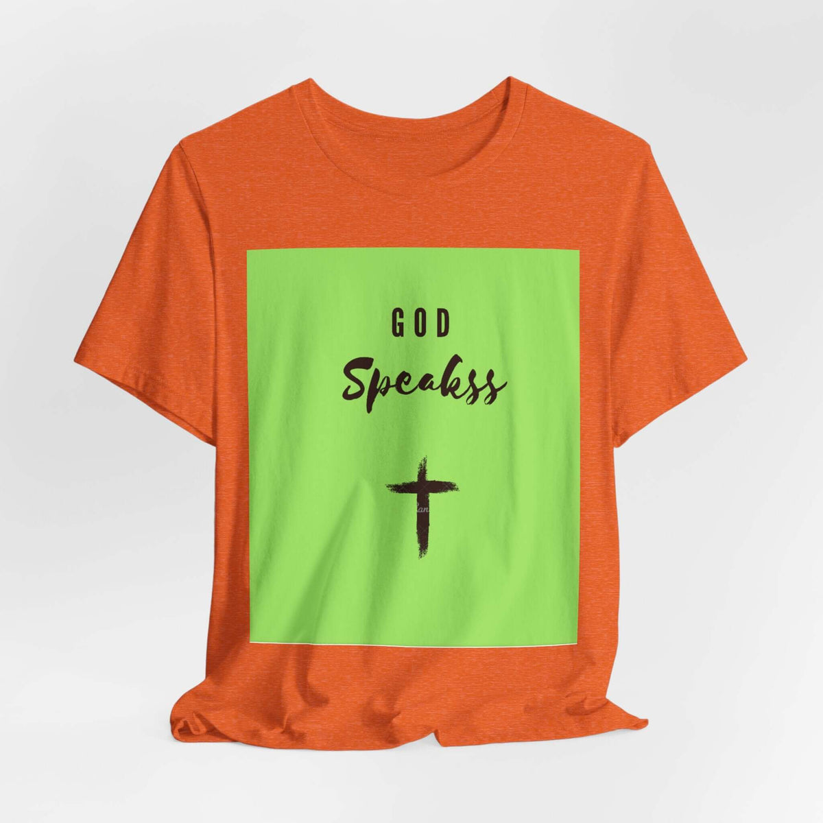 God Speakss Unisex Jersey in orange with green graphic featuring 'God Speakss' and a cross design.